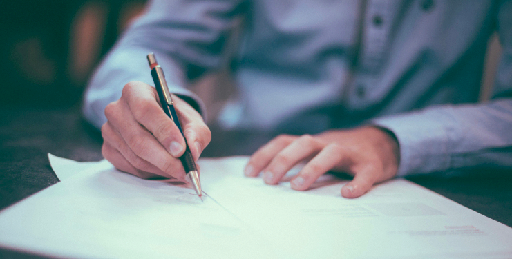A photo of a person writing a document